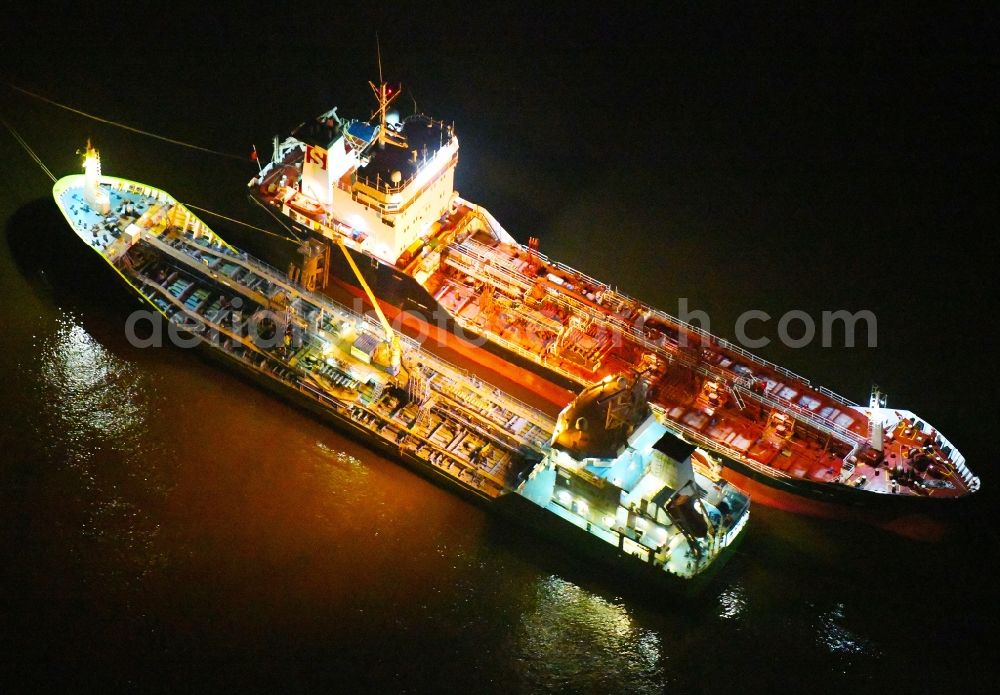 Hamburg at night from the bird perspective: Night lighting cargo ships - Tanker for Oil and Chemicals in the district HafenCity in Hamburg, Germany