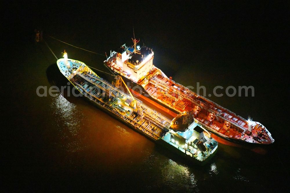 Aerial photograph at night Hamburg - Night lighting cargo ships - Tanker for Oil and Chemicals in the district HafenCity in Hamburg, Germany