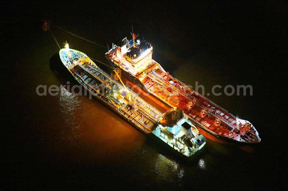 Aerial image at night Hamburg - Night lighting cargo ships - Tanker for Oil and Chemicals in the district HafenCity in Hamburg, Germany