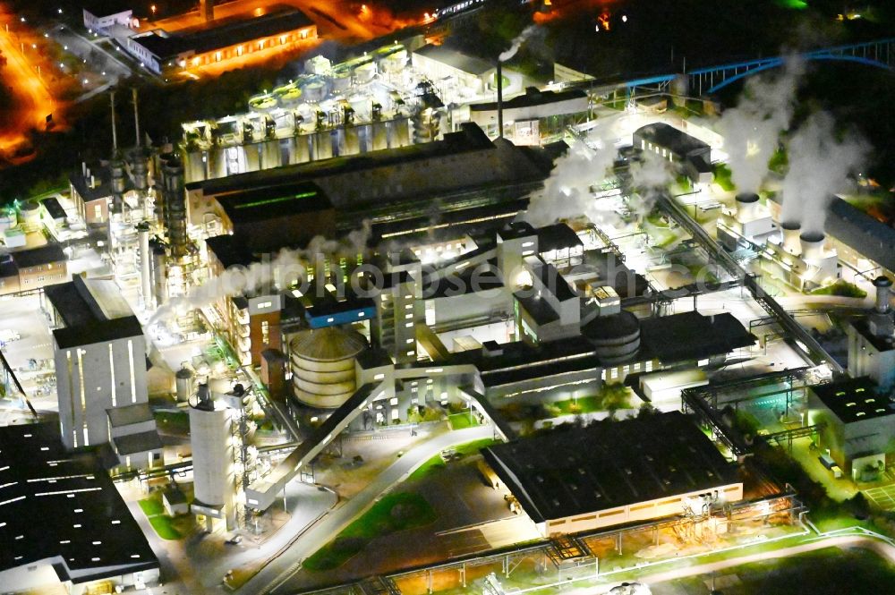 Bernburg (Saale) at night from the bird perspective: Night lighting technical facilities in the industrial area of Industriepark Solvay in Bernburg (Saale) in the state Saxony-Anhalt, Germany