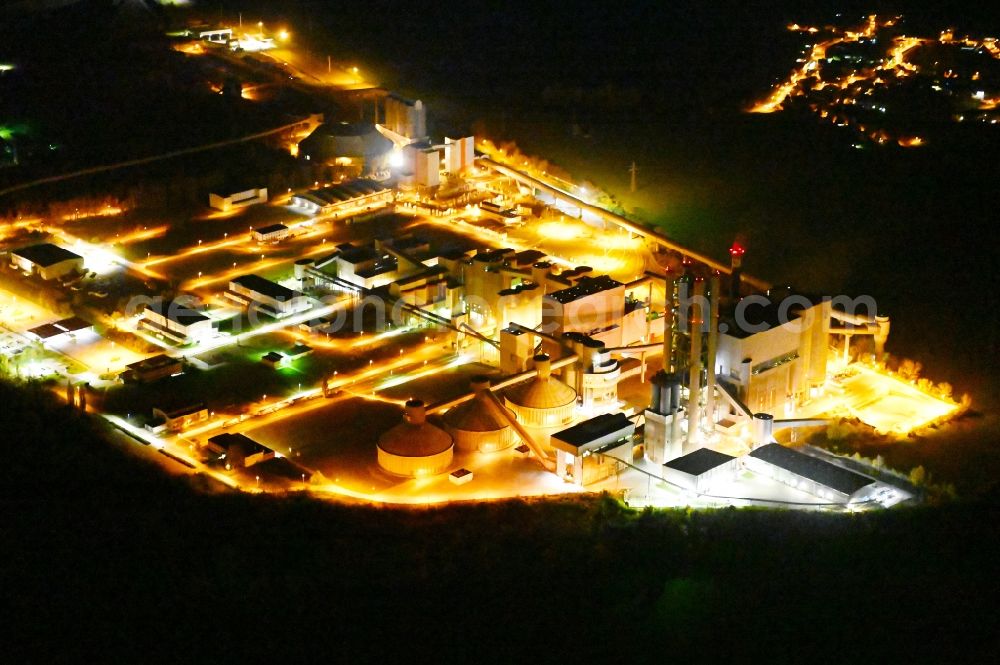 Aerial image at night Bernburg (Saale) - Night lighting technical facilities in the industrial area of Schwenk Zementwerke in Bernburg (Saale) in the state Saxony-Anhalt, Germany