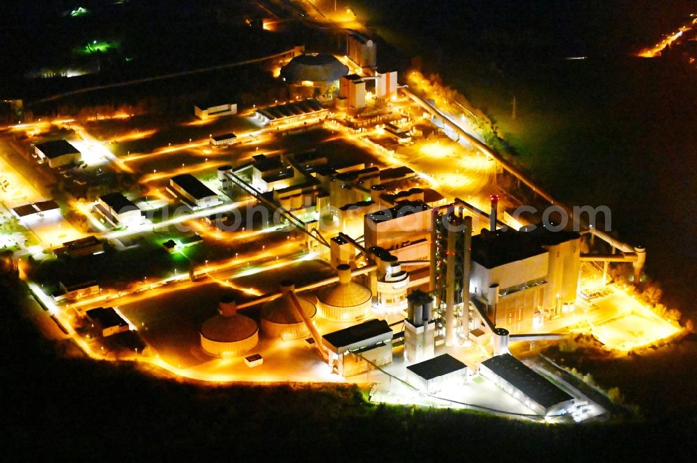 Bernburg (Saale) at night from the bird perspective: Night lighting technical facilities in the industrial area of Schwenk Zementwerke in Bernburg (Saale) in the state Saxony-Anhalt, Germany