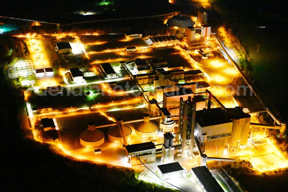 Aerial photograph at night Bernburg (Saale) - Night lighting technical facilities in the industrial area of Schwenk Zementwerke in Bernburg (Saale) in the state Saxony-Anhalt, Germany