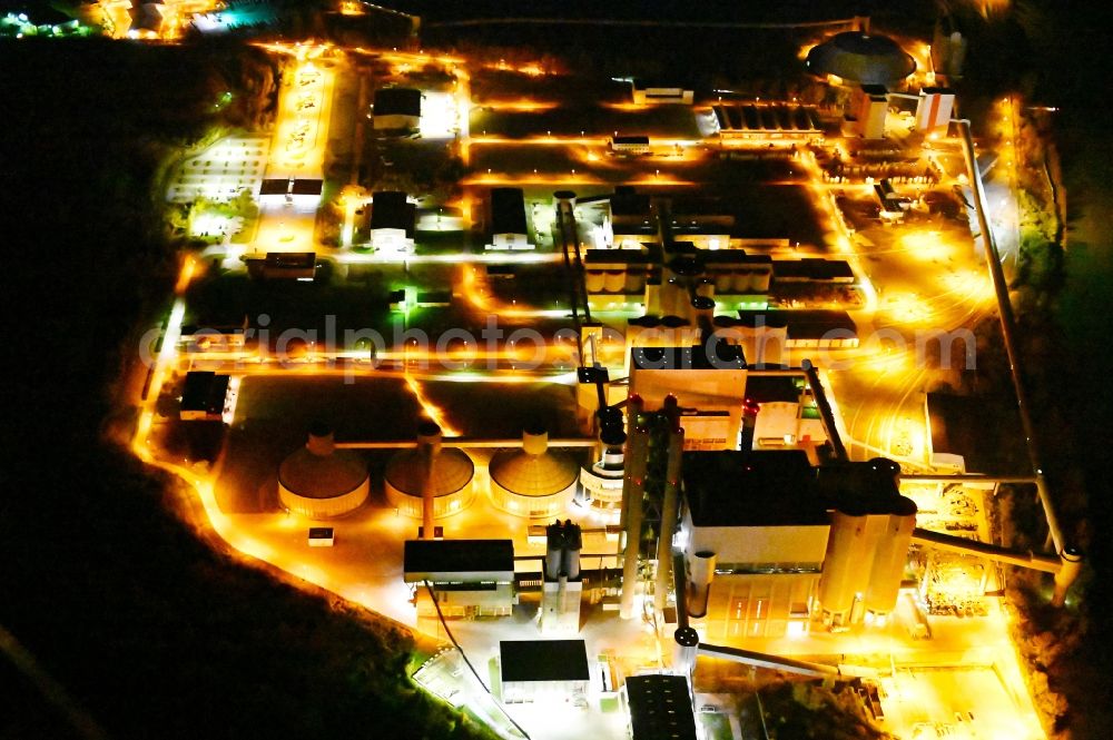 Aerial image at night Bernburg (Saale) - Night lighting technical facilities in the industrial area of Schwenk Zementwerke in Bernburg (Saale) in the state Saxony-Anhalt, Germany