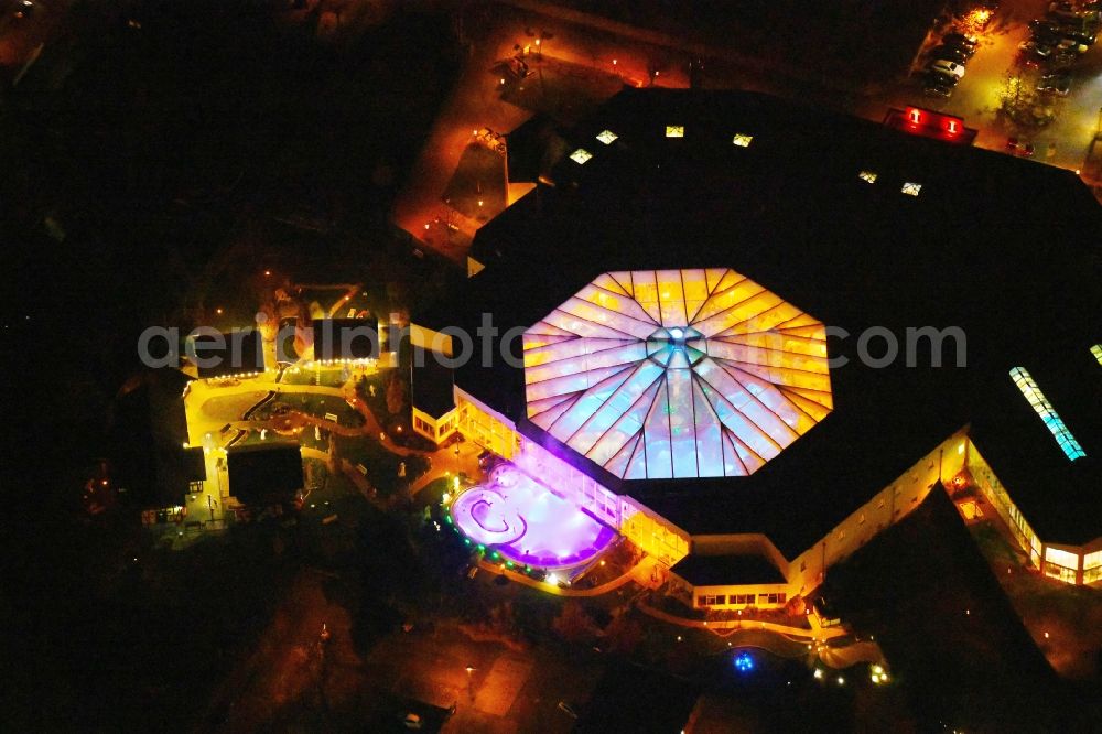 Ludwigsfelde at night from above - Night lighting Spa and swimming pools at the swimming pool of the leisure facility of Kristall Baeof AG in Ludwigsfelde in the state Brandenburg, Germany