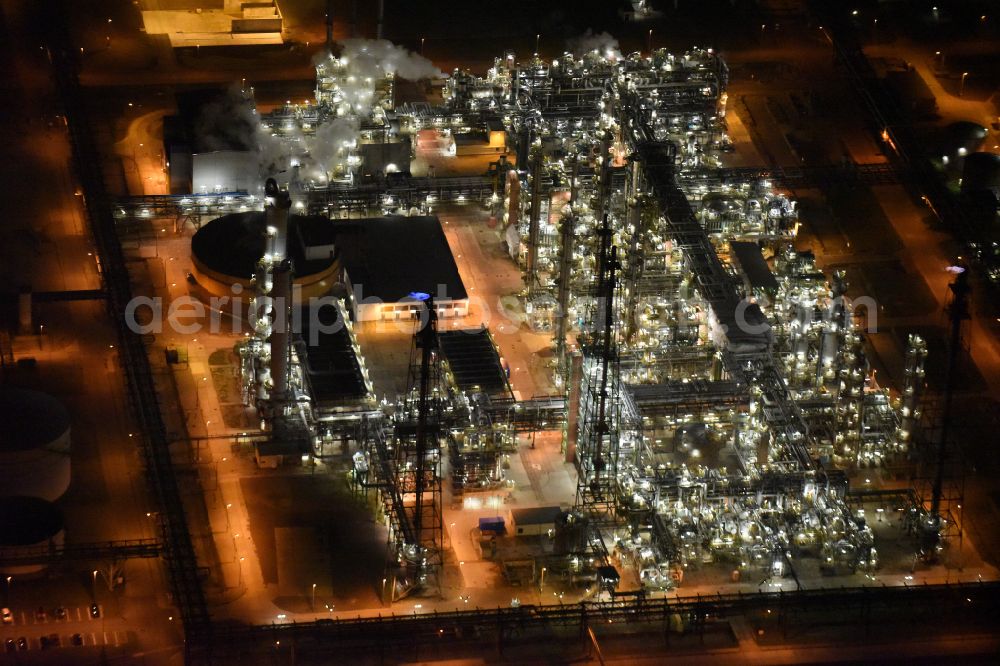 Aerial photograph at night Leuna - Night lighting tOTAL refinery in central Germany in Leuna in the federal state of Saxony-Anhalt. The TOTAL refinery chemical site Leuna is one of the most modern refineries in Europe