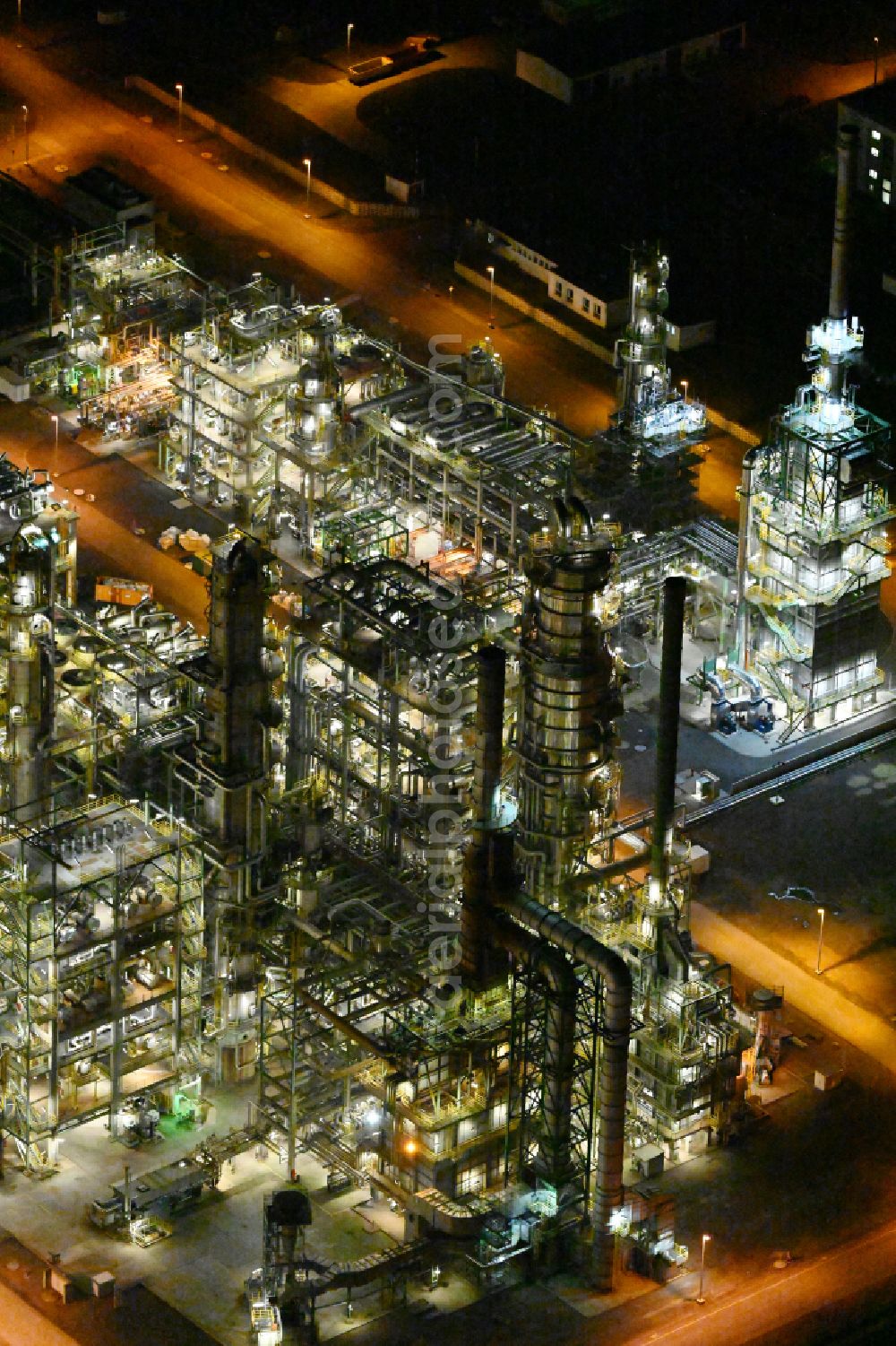 Aerial photograph at night Leuna - Night lighting tOTAL refinery in central Germany in Leuna in the federal state of Saxony-Anhalt. The TOTAL refinery chemical site Leuna is one of the most modern refineries in Europe