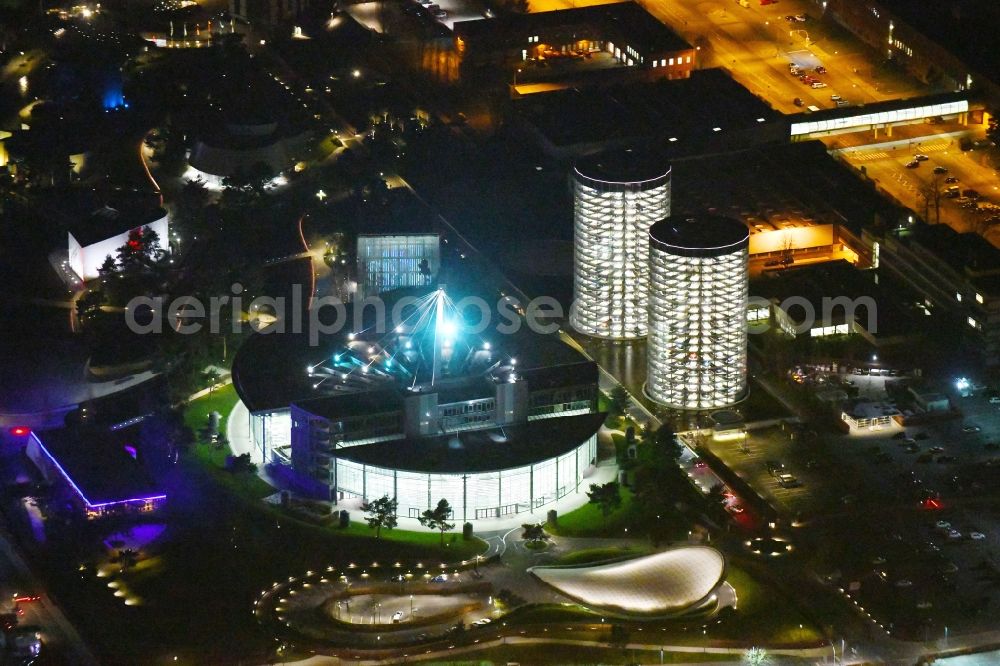 Aerial image at night Wolfsburg - Night lighting Tourist attraction and sightseeing Autostadt GmbH on factorysgelaende of Volkswagen AG in Wolfsburg in the state Lower Saxony, Germany