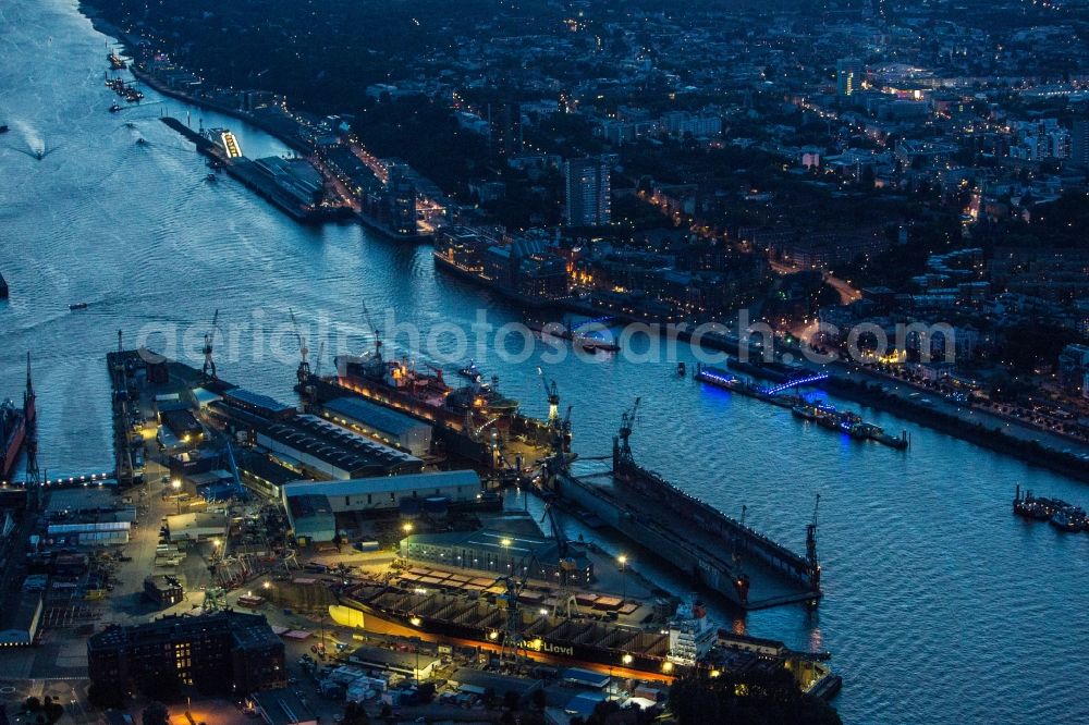 Hamburg at night from above - Night view of installation work on a tanker hull in dry dock / Blohm and Voss Dock Elbe in Hamburg. Clearly visible are the different sections of the Scots and future tanker. The dry dock Elbe 17 is one of the largest dry dock in Europe. It is located on the grounds of the Blohm + Voss shipyard in Hamburg