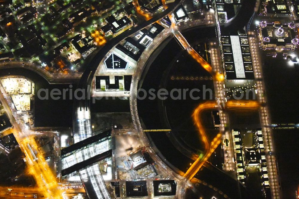 Aerial image at night Berlin - Night lighting Riparian zones on the course of the river of Spree on Central Station in the district Mitte in Berlin, Germany