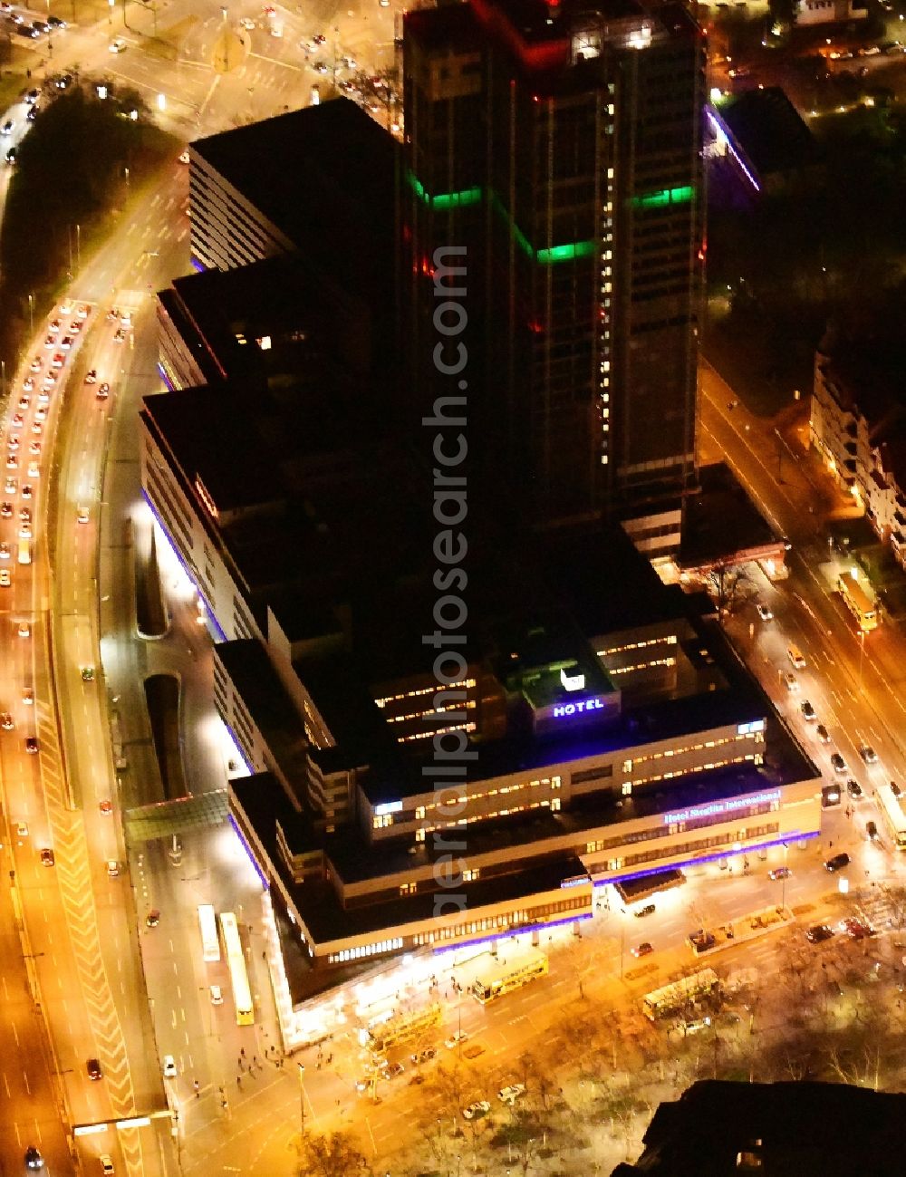 Aerial image at night Berlin - Night lighting highrise building of the Steglitzer Kreisel - UeBERLIN Wohntower complex on Schlossstrasse in the district of Steglitz in Berlin