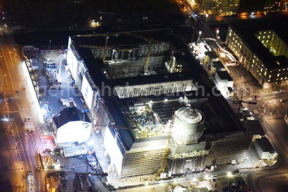 Aerial photograph at night Berlin - Night view of construction site for the new building the largest and most important cultural construction of the Federal Republic, the building of the Humboldt Forum in the form of the Berlin Palace