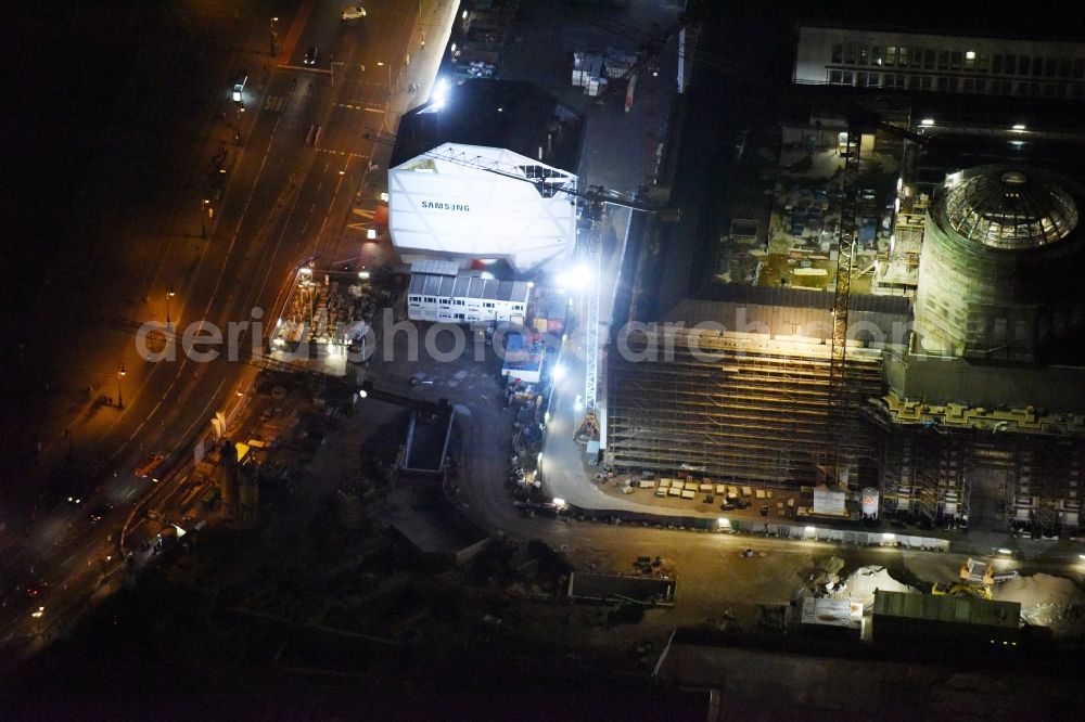 Aerial photograph at night Berlin - Night view of construction site for the new building the largest and most important cultural construction of the Federal Republic, the building of the Humboldt Forum in the form of the Berlin Palace