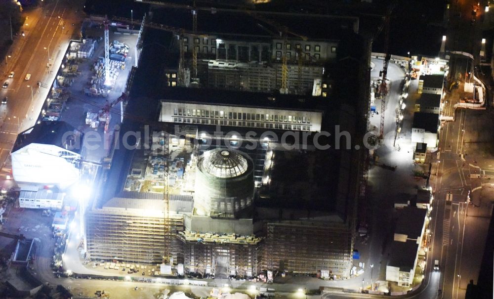 Aerial image at night Berlin - Night view of construction site for the new building the largest and most important cultural construction of the Federal Republic, the building of the Humboldt Forum in the form of the Berlin Palace