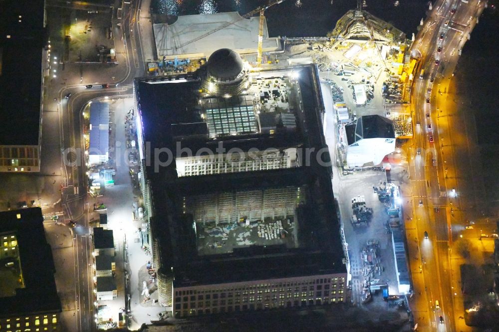 Aerial image at night Berlin - Night lighting Construction site for the new building the largest and most important cultural construction of the Federal Republic, the building of the Humboldt Forum in the form of the Berlin Palace