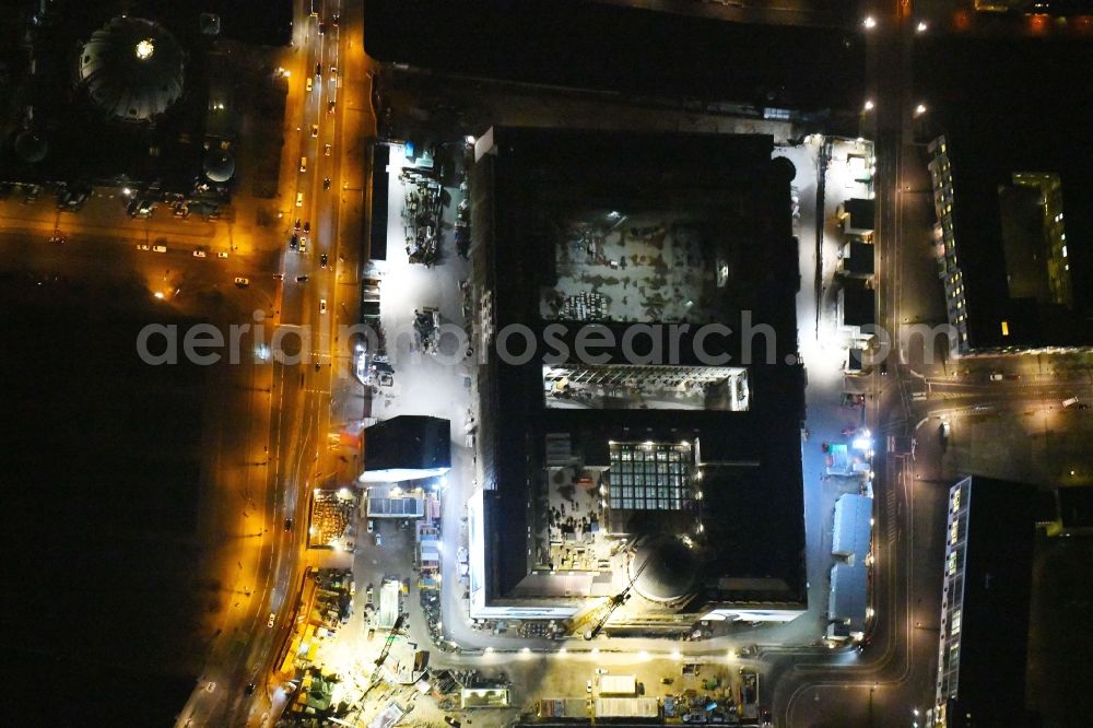 Aerial photograph at night Berlin - Night lighting Construction site for the new building the largest and most important cultural construction of the Federal Republic, the building of the Humboldt Forum in the form of the Berlin Palace