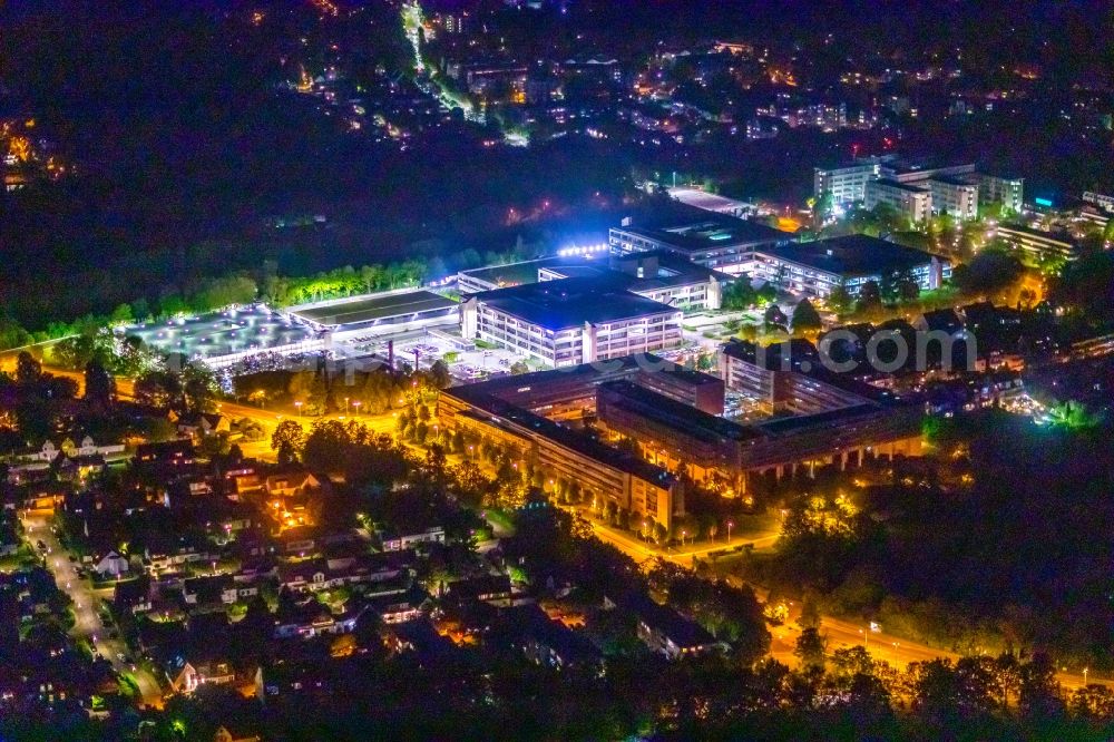 Essen at night from the bird perspective: Night lighting administration building of the company Dussmann Service Deutschland GmbH, MDK and MDS and of Rhenus Automotive Systems GmbH in the district Werden in Essen at Ruhrgebiet in the state North Rhine-Westphalia, Germany