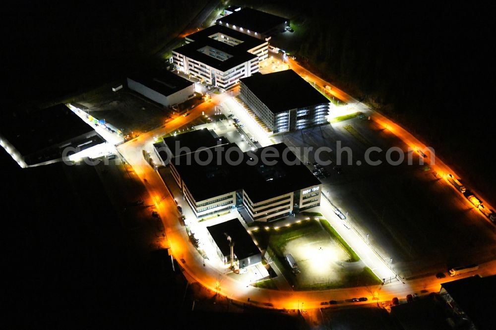 Aerial image at night Mönsheim - Night lighting administration building of the company of Bertrandt AG on Friedrichshof and of the Porsche Engineering Group GmbH Am Dieb in Moensheim in the state Baden-Wurttemberg, Germany