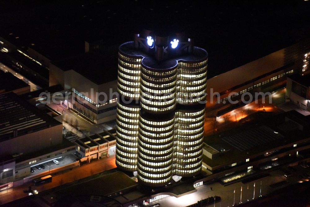 Aerial image at night München - Night lighting administration building of the company Vierzylinof of BMW AG in the district Milbertshofen-Am Hart in Munich in the state Bavaria, Germany