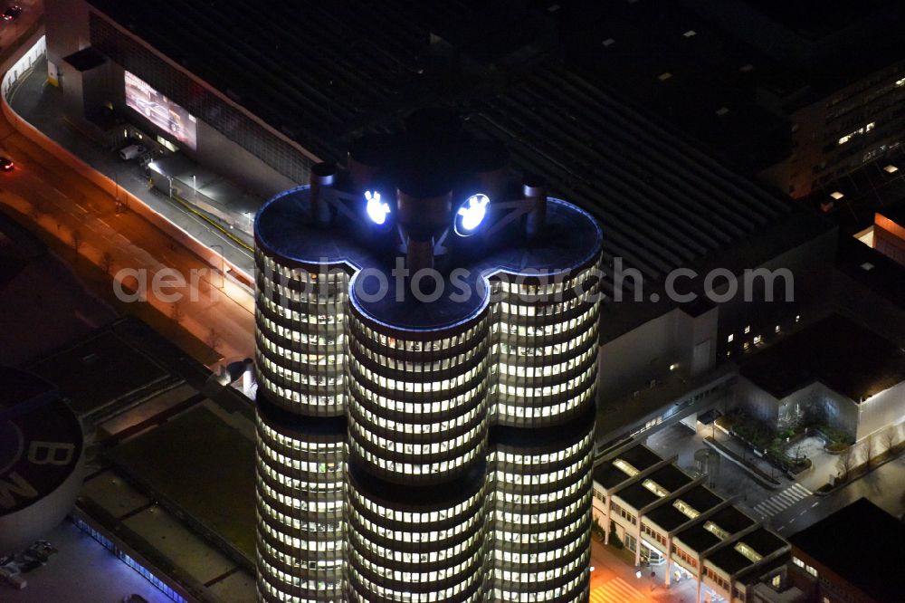 München at night from above - Night lighting administration building of the company Vierzylinof of BMW AG in the district Milbertshofen-Am Hart in Munich in the state Bavaria, Germany