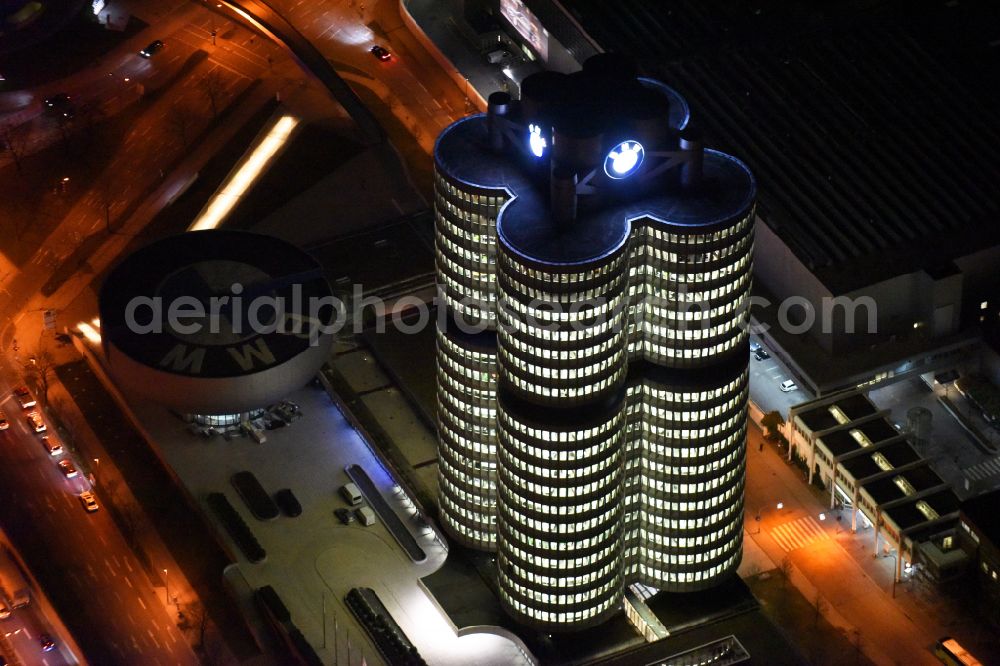 Aerial image at night München - Night lighting administration building of the company Vierzylinof of BMW AG in the district Milbertshofen-Am Hart in Munich in the state Bavaria, Germany