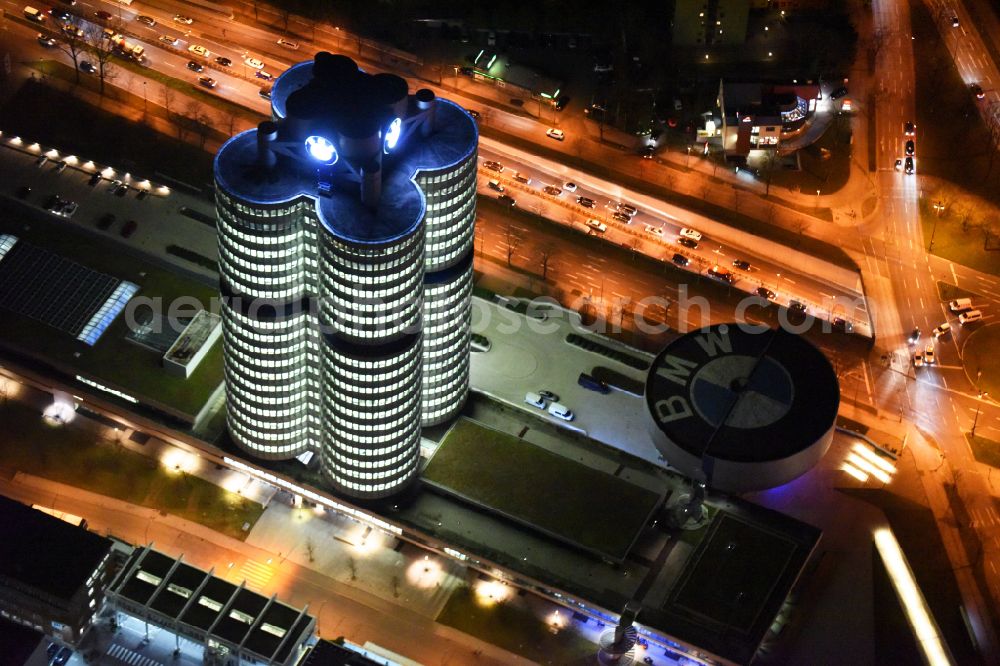 Aerial image at night München - Night lighting administration building of the company Vierzylinof of BMW AG in the district Milbertshofen-Am Hart in Munich in the state Bavaria, Germany