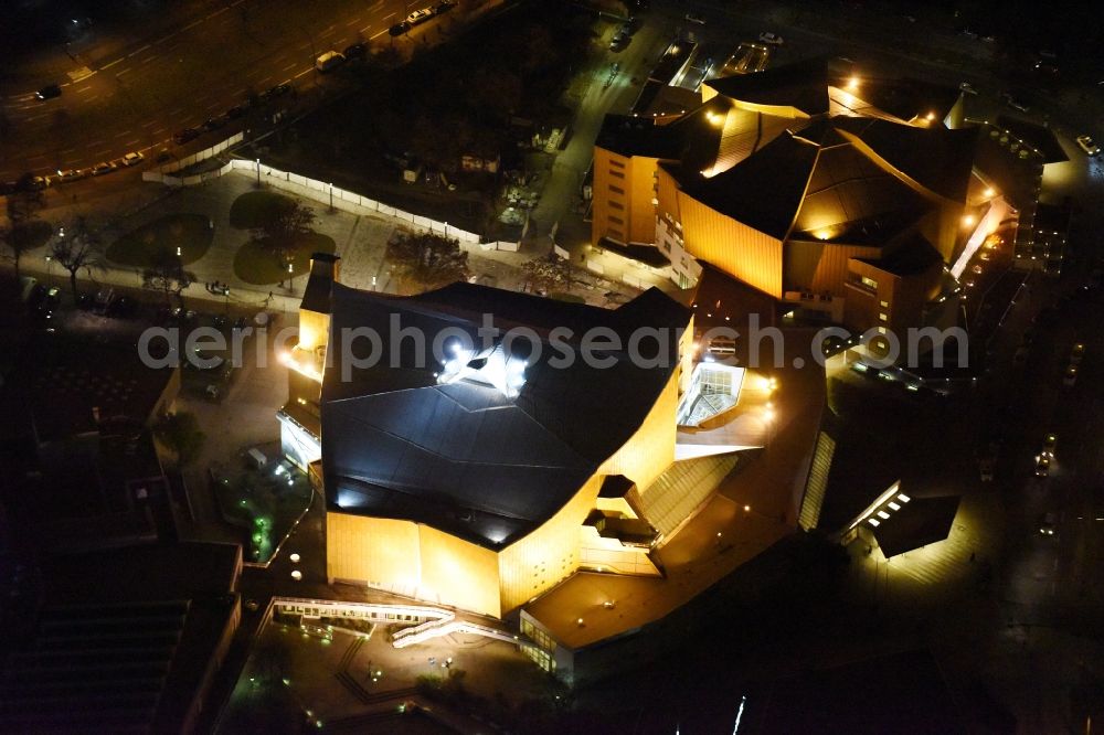 Aerial image at night Berlin - Night view building the indoor arena Berliner Philharmonie om Herbert-von-Karajan-Strasse in Berlin in Germany