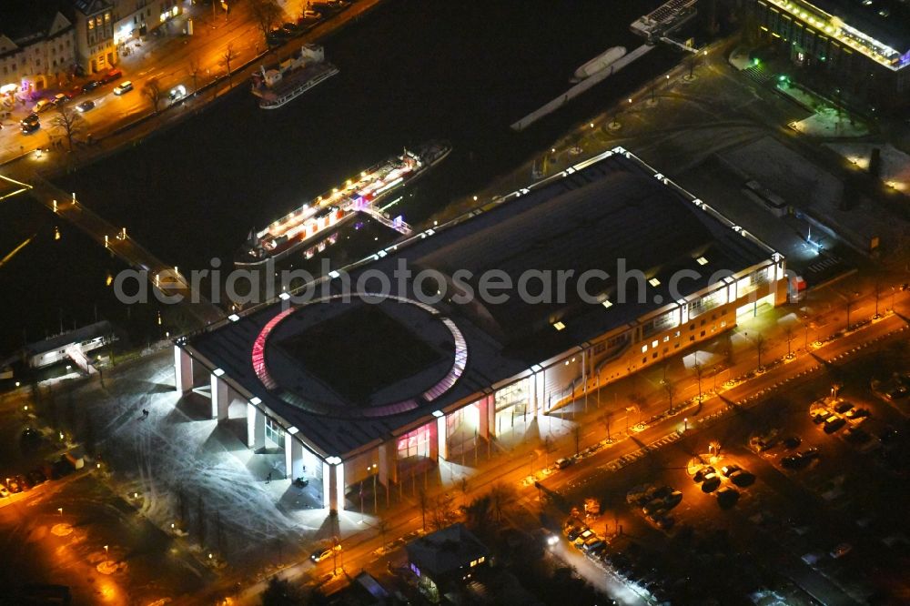 Lübeck at night from above - Night lighting building the indoor arena Musik- und Kongresshalle und Theaterschiff Luebeck an der Willy-Brandt-Allee in Luebeck in the state Schleswig-Holstein