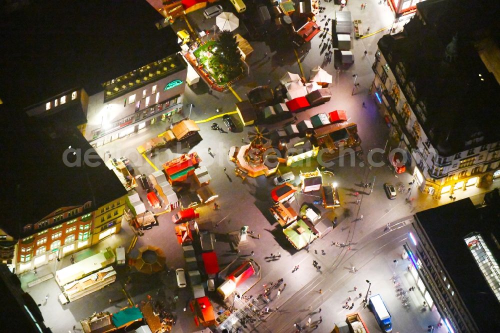 Aerial image at night Halle (Saale) - Night lighting Sale and food stands and trade stalls in the market place on Marktplatz on Roter Turm in Halle (Saale) in the state Saxony-Anhalt, Germany