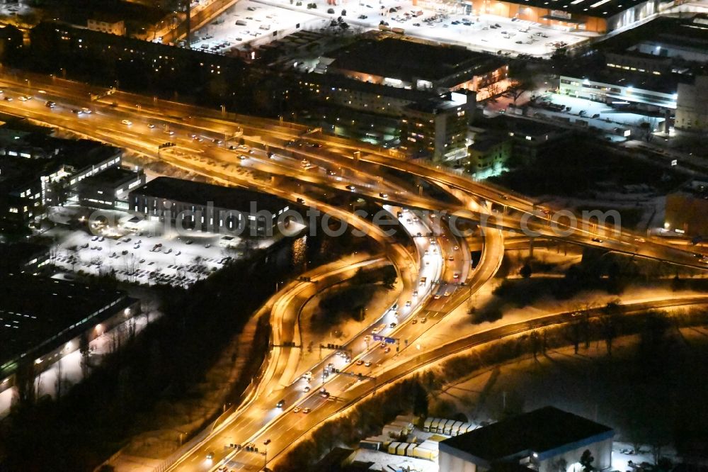 Berlin at night from the bird perspective: Night view course of the federal motorway A100 and A113 in the area of the exit Grenzallee in the Neukoelln part of Berlin in Germany