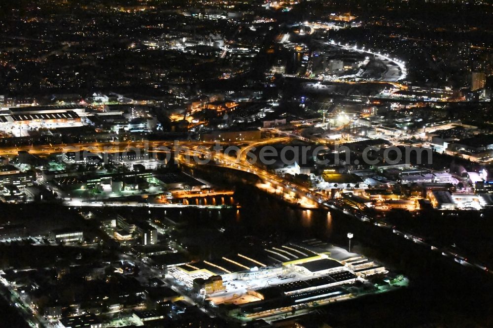 Berlin at night from the bird perspective: Night view course of the federal motorway A100 and A113 in the area of the exit Grenzallee in the Neukoelln part of Berlin in Germany