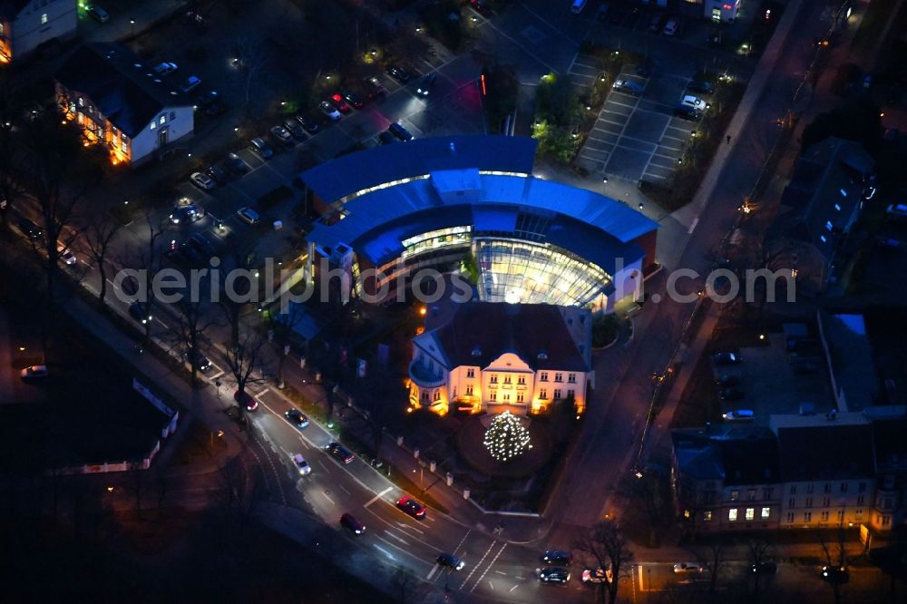 Neuruppin at night from above - Night lighting Banking administration building of the financial services company Sparkasse Ostprignitz-Ruppin - Geschaeftsstelle on Fontaneplatz in Neuruppin in the state Brandenburg, Germany