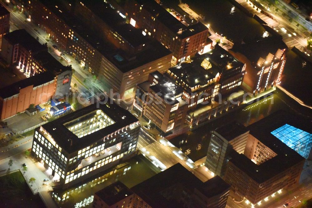 Aerial photograph at night Hamburg - Night view administration building of the company Marquard & Bahls AG and the brothers Heinemann SE & Co. KG in the Koreastrasse - Shanghaiallee in Hamburg. Right next to it the international maritime museum