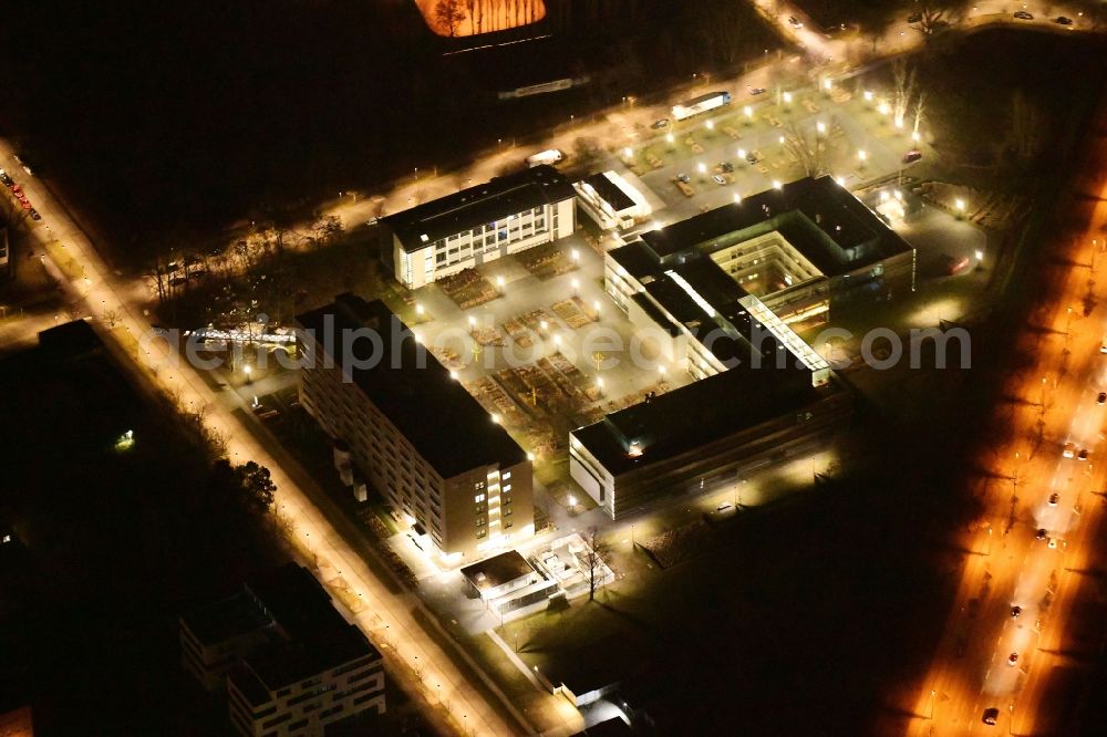 Aerial image at night Berlin - Night lighting administrative building of the State Authority Bandesanstalt fuer Materialforschung and -pruefung an of Richard-Willstaetter-Strasse in the district Adlershof in Berlin, Germany