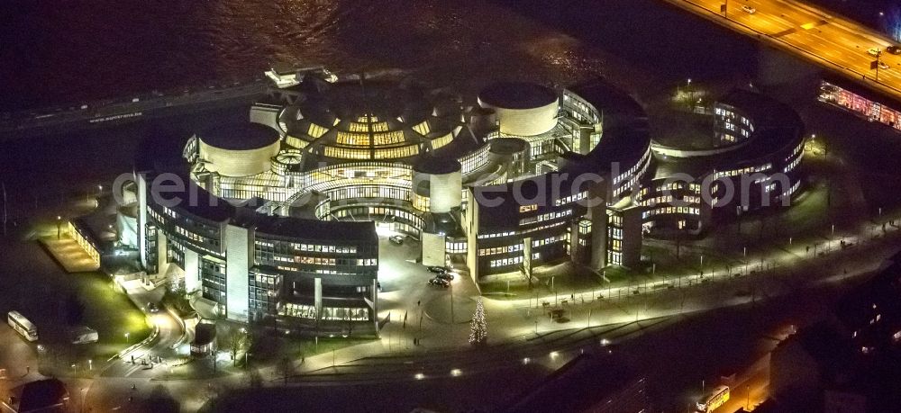 Aerial photograph at night Düsseldorf - Night aerial view of the illuminated buildings of the state parliament of North Rhine-Westphalia on the Rhine in Dusseldorf