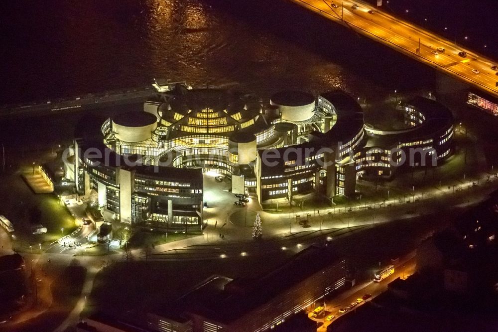 Aerial image at night Düsseldorf - Night aerial view of the illuminated buildings of the state parliament of North Rhine-Westphalia on the Rhine in Dusseldorf