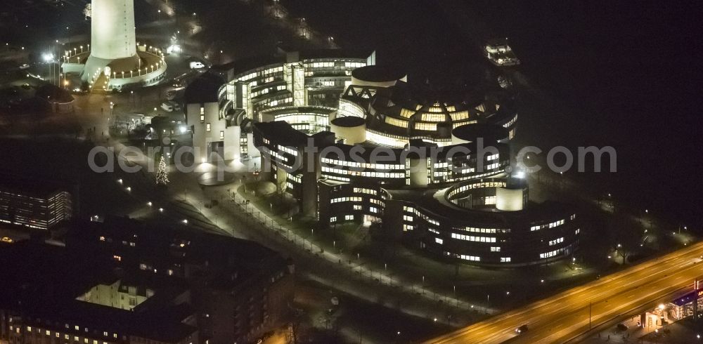 Düsseldorf at night from the bird perspective: Night aerial view of the illuminated buildings of the state parliament of North Rhine-Westphalia on the Rhine in Dusseldorf