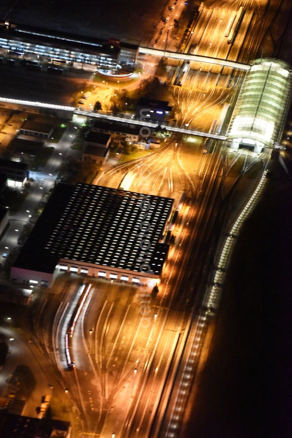 Aerial image at night München - Night aerial view from the depot of the S-Bahn in Munich in Bavaria. Behind the subway stop Froettmaning