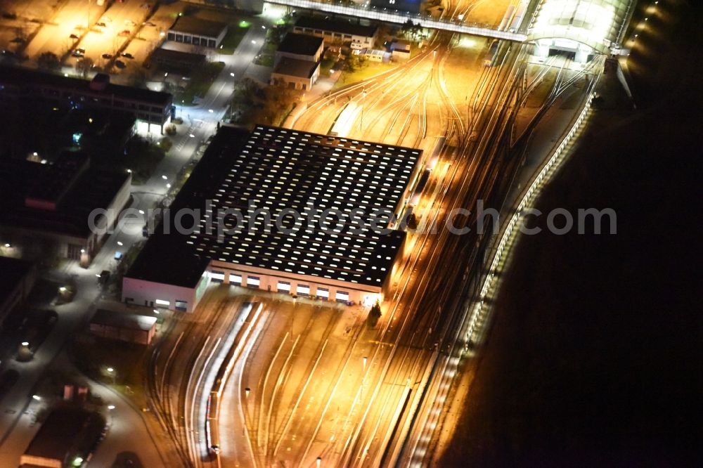 München at night from above - Night aerial view from the depot of the S-Bahn in Munich in Bavaria. Behind the subway stop Froettmaning