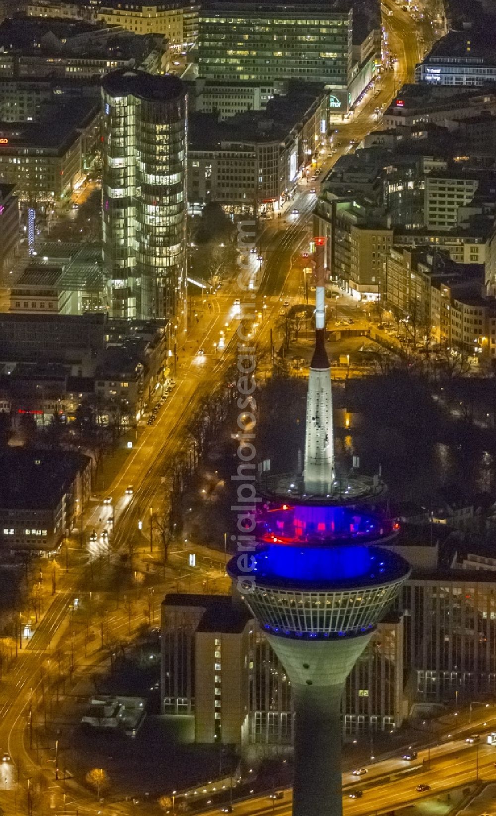 Aerial image at night Düsseldorf - View of the telecommunications tower Rheinturm in Dusseldorf in the state North Rhine-Westhalia. The Rheinturm carries aerials for directional radio, FM and TV transmitters and DVB-T