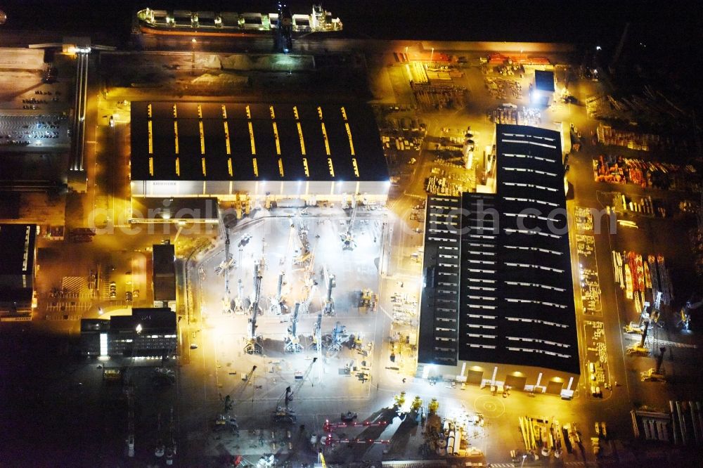 Rostock at night from above - Night view company grounds and facilities of Liebherr-MCCtec GmbH in Rostock in the state Mecklenburg - Western Pomerania