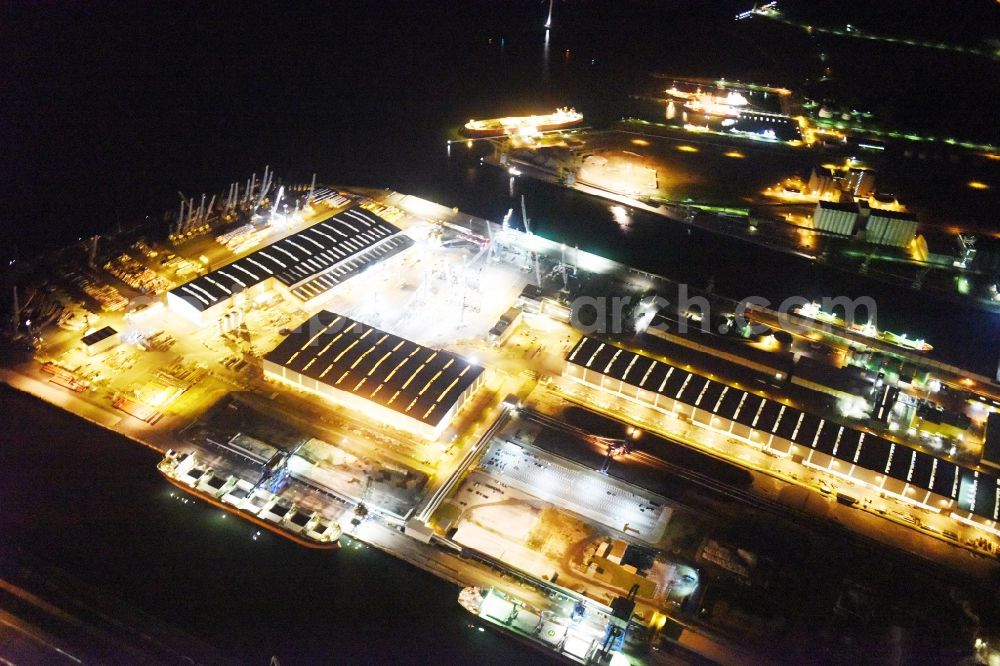 Rostock at night from above - Night view company grounds and facilities of Liebherr-MCCtec GmbH in Rostock in the state Mecklenburg - Western Pomerania