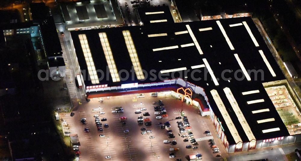 Lübeck at night from the bird perspective: Night view building of the construction market Bauhaus in the district Sankt Lorenz Nord in Luebeck in the state Schleswig-Holstein