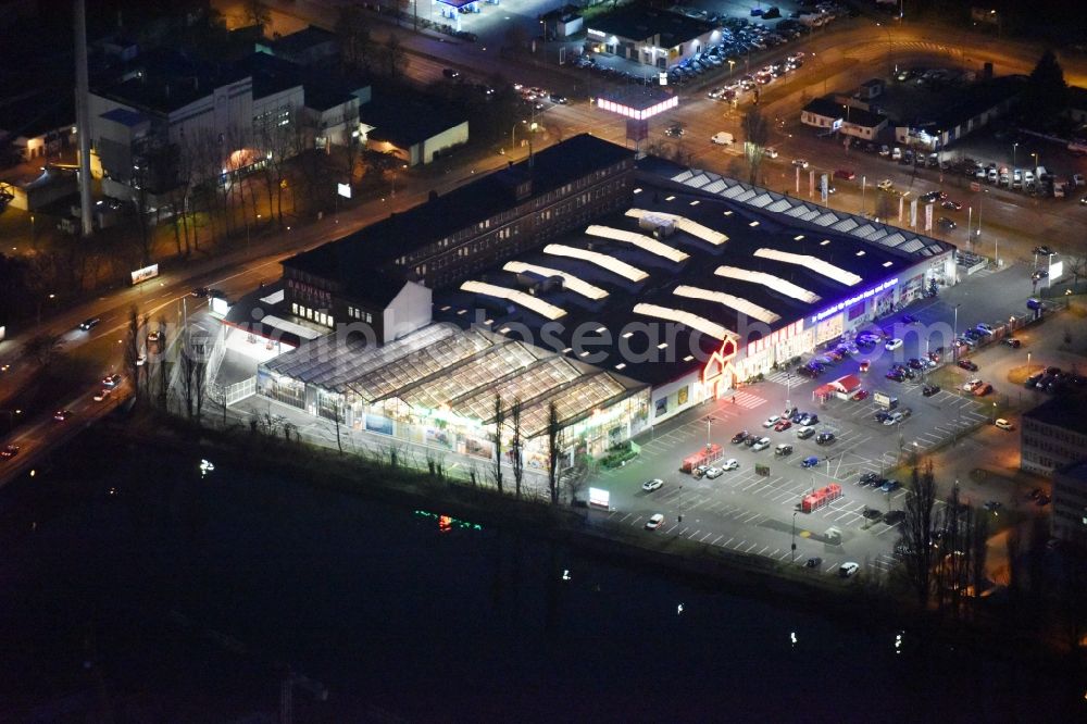 Aerial photograph at night Berlin - Night view building of the construction market of Bauhaus AG in the Karlshorster street in the district Niederschoeneweide in Berlin