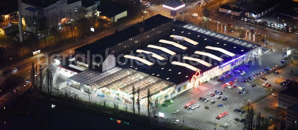 Aerial image at night Berlin - Night view building of the construction market of Bauhaus AG in the Karlshorster street in the district Niederschoeneweide in Berlin