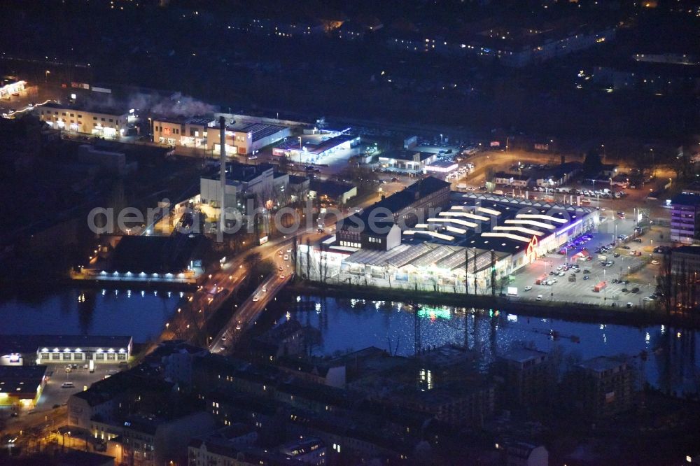 Aerial photograph at night Berlin - Night view building of the construction market of Bauhaus AG in the Karlshorster street in the district Niederschoeneweide in Berlin