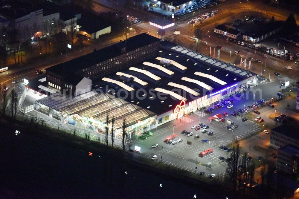 Aerial image at night Berlin - Night view building of the construction market of Bauhaus AG in the Karlshorster street in the district Niederschoeneweide in Berlin