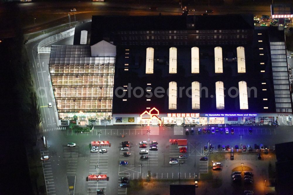 Berlin at night from the bird perspective: Night view building of the construction market of Bauhaus AG in the Karlshorster street in the district Niederschoeneweide in Berlin