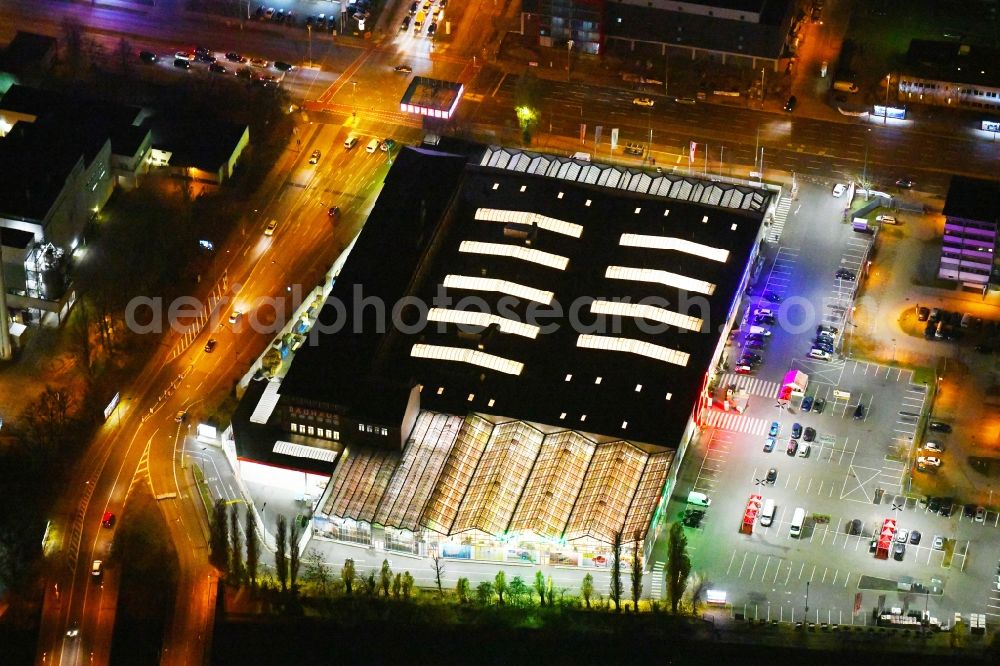 Aerial image at night Berlin - Night lighting Building of the construction market Bauhaus Schnellerstrasse - federal road B96a - Karlshorster Strasse in the district Treptow in Berlin