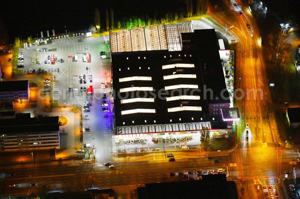 Aerial photograph at night Berlin - Night lighting Building of the construction market Bauhaus Schnellerstrasse - federal road B96a - Karlshorster Strasse in the district Treptow in Berlin